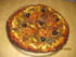 Pizza aux courgettes, tomates noires et parmesan